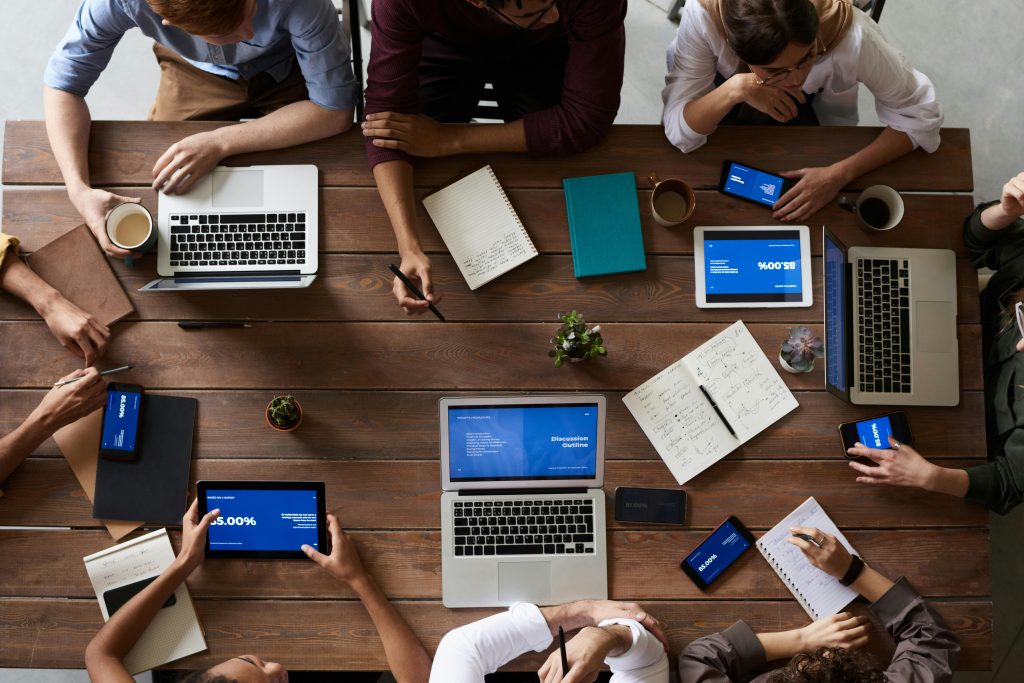 pexels photo 3183150 3183150 Overhead view of a diverse team in a business meeting using laptops and tablets.